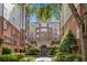 Brick building with landscaped courtyard and trees at 50 Biscayne Nw Dr # 6113, Atlanta, GA 30309