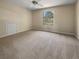 Bright bedroom featuring a window, ceiling fan and carpet at 9997 Point View Dr, Jonesboro, GA 30238
