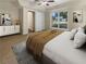 Virtually staged main bedroom with large window and access to hallway at 9997 Point View Dr, Jonesboro, GA 30238