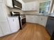 Kitchen with white cabinets, stainless steel appliances, and bamboo floors at 9997 Point View Dr, Jonesboro, GA 30238
