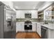 Modern kitchen with stainless steel appliances and white cabinets at 1834 Avon Sw Ave, Atlanta, GA 30311