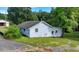 Image shows a light blue house with windows, a yard, and trees in the background at 5690 Abbotts Bridge Rd, Johns Creek, GA 30097