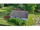 Aerial view of a light blue house with dark gray roof, surrounded by lush green vegetation at 5690 Abbotts Bridge Rd, Johns Creek, GA 30097