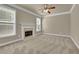 Living room with fireplace, neutral carpet, and large windows at 3438 Old Towne Ln, Cumming, GA 30040