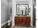 Bathroom with dark wood vanity and granite countertop at 570 Stonemoor Cir, Roswell, GA 30075