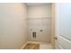 Laundry room with shelving and built-in washer/dryer at 200 Etris Grove Ct, Roswell, GA 30075