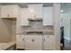 Kitchen features white cabinets, granite countertops and gas cooktop at 200 Etris Grove Ct, Roswell, GA 30075