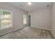 Well-lit bedroom with carpet and two windows at 200 Etris Grove Ct, Roswell, GA 30075