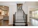 Elegant staircase with dark wood railing and white risers at 200 Etris Grove Ct, Roswell, GA 30075