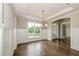 Bright dining room features hardwood floors, large windows, and elegant chandelier at 200 Etris Grove Ct, Roswell, GA 30075