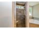 Walk-in shower with gray tile and bench seat at 200 Etris Grove Ct, Roswell, GA 30075