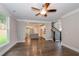 Open living room with hardwood floors, kitchen and staircase views at 200 Etris Grove Ct, Roswell, GA 30075