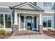 Front entrance with brick columns and a glass door at 200 Etris Grove Ct, Roswell, GA 30075