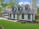 House exterior featuring a newly renovated white facade, gray roof and large windows at 1161 Appian Way, Lawrenceville, GA 30046