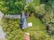 Aerial view showing a house nestled in lush greenery with a spacious backyard at 1161 Appian Way, Lawrenceville, GA 30046