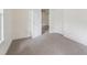 Simple carpeted bedroom with open door to another room at 5665 Austell Powder Springs Rd, Austell, GA 30106