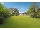Private backyard with green grass and trees at 5665 Austell Powder Springs Rd, Austell, GA 30106