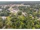 Aerial view showing home nestled in wooded lot with nearby businesses at 5665 Austell Powder Springs Rd, Austell, GA 30106