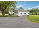 White house with front porch, driveway, and yard at 5665 Austell Powder Springs Rd, Austell, GA 30106