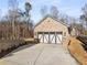 Detached garage with three-car doors and brick exterior at 3195 Camp Branch Rd, Buford, GA 30519