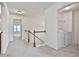 Upstairs hallway with laundry access and carpet at 5661 Radford Loop, Fairburn, GA 30213