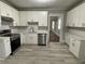 Modern kitchen with white cabinets and stainless steel appliances at 916 Cascade Sw Rd, Atlanta, GA 30311