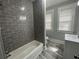 Updated bathroom with gray tile shower and vanity at 916 Cascade Sw Rd, Atlanta, GA 30311