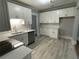 Bright kitchen with white cabinets and gray quartz countertops at 916 Cascade Sw Rd, Atlanta, GA 30311