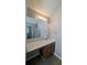 Vanity with wood cabinets and a large mirror at 3008 Summer Breeze Dr, Villa Rica, GA 30180