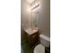 Clean bathroom with single sink vanity, toilet and light fixture at 3008 Summer Breeze Dr, Villa Rica, GA 30180