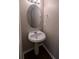 Clean and updated half bathroom with pedestal sink and oval mirror at 3008 Summer Breeze Dr, Villa Rica, GA 30180