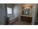 Bathroom boasts a garden tub, vanity, and tile floor at 3008 Summer Breeze Dr, Villa Rica, GA 30180