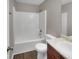 Bathroom with tub/shower combo, wood vanity, and updated toilet at 7458 Spoleto Loop, Fairburn, GA 30213