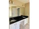 Bathroom with double vanity, granite countertops and white cabinets at 1321 Webb Farm Ln, Loganville, GA 30052