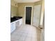 Main bathroom with double vanity, granite countertops and tile floors at 1321 Webb Farm Ln, Loganville, GA 30052