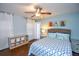 Bedroom with a double bed, light blue walls, and dark hardwood floors at 6619 Bass Cir, Buford, GA 30518