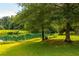 Picturesque pond with lush green banks and trees at 6000 South Ave, Austell, GA 30168