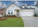 Craftsman style home with two car garage and manicured lawn at 5109 Aster Bnd, Canton, GA 30114