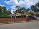 Charming yellow house with unique architectural details and a brick wall at 678 Quillian Ave, Decatur, GA 30032