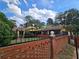 Yellow house with a brick wall and black metal fence at 678 Quillian Ave, Decatur, GA 30032