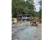 Large backyard with a two story gray building, picnic table, and basketball goal at 678 Quillian Ave, Decatur, GA 30032