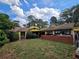 Yellow house with a large yard and brick wall at 678 Quillian Ave, Decatur, GA 30032