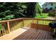 Spacious deck with wooden railings, overlooking a wooded backyard at 895 Indian Lake Nw Dr, Lilburn, GA 30047