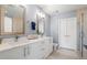 Modern bathroom with dual vanities, quartz countertops, and a walk-in shower at 1080 Peachtree Ne St # 1504, Atlanta, GA 30309