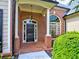 Brick front exterior with a welcoming porch and landscaping at 1791 Rosehedge Nw Way, Kennesaw, GA 30152