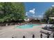 Community pool with lounge chairs and umbrellas at 1515 Stone Gate Se Ln, Atlanta, GA 30317