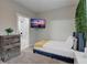 Cozy bedroom with a full bed, en-suite bathroom access, and a mounted TV at 975 Welch Sw St, Atlanta, GA 30310