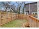Fenced backyard with grassy area and wooden deck access at 975 Welch Sw St, Atlanta, GA 30310