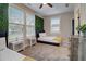 Spacious bedroom with two twin beds, a dresser, and a view of the backyard at 975 Welch Sw St, Atlanta, GA 30310