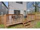 Private backyard with a wooden deck, string lights, and a stone pathway at 975 Welch Sw St, Atlanta, GA 30310